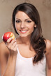 Smiling woman holding apple