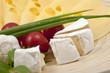 Various types of cheese on a wooden board Various types of cheese on a wooden board