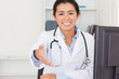 Attractive female doctor inviting somebody to seat while looking