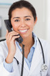 Pretty female doctor on the phone and posing