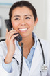 Beautiful female doctor on the phone and posing