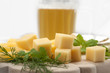 Various types of cheese on a wooden board with beer Various types of cheese on a wooden board with beer