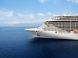 Luxury cruise ship sailing from port.