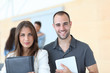 Portrait of college students standing in college hall