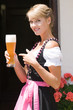 Junge Frau im Dirndl mit Weißbier