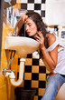 Woman with sickness  into toilet.