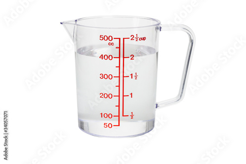 Photo: Plastic kitchen measuring cup filled with water Plastic kitchen measuring cup filled with water