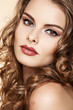 Sensual pin-up model with bright lips make-up & curly hairs