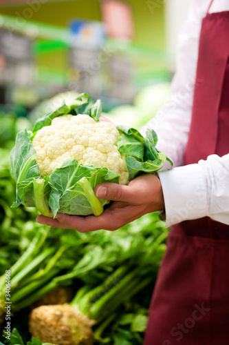 Photo: Man in supermarket as shop assistant Man in supermarket as shop assistant