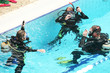 divers training at the pool