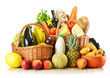 Groceries in wicker basket isolated on white