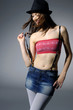 Sexy young woman in hat with great body wearing jeans Sexy young woman in hat with great body wearing jeans