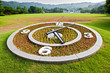 Round flower clock on lawn background