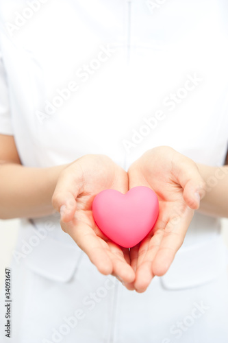 Photo: a nurse holding a symbol of heart a nurse holding a symbol of heart
