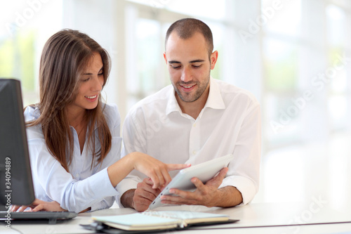 Photo: Young adults in training course using touchpad Young adults in training course using touchpad