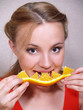 beautiful girl eats an orange segment