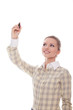 Smiling businesswoman writes at the top of the marker in front o