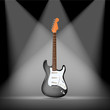 black electric guitars on spotlight background