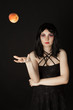Woman with halloweeen make up sthrowing peach Woman with halloweeen make up sthrowing peach
