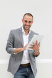 Cool businessman using electronic tablet on white background