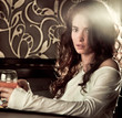 woman drinking cocktail in cafe bar