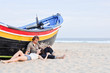 Romantic couple and boat on the beach Romantic couple and boat on the beach