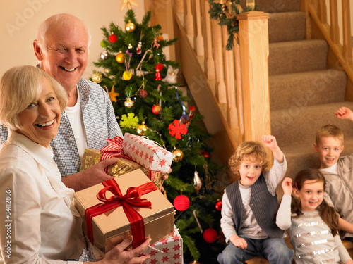 Photo: Senior couple with grandchildren at Christmas Senior couple with grandchildren at Christmas