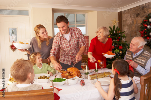 Photo: Family serving Christmas dinner Family serving Christmas dinner