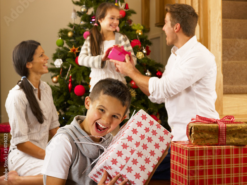 Photo: Hispanic family exchanging gifts at Christmas Hispanic family exchanging gifts at Christmas