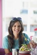 Portrait of a beautiful woman eating food in a restaurant