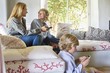 Children and mother using electronic gadgets at home