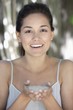 Portrait of a beautiful young woman holding bath salt in hand