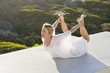 Mid adult woman practicing yoga exercise at terrace