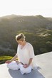 Mid adult woman meditating