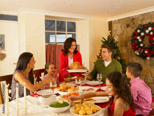 Photo: Hispanic family serving Christmas dinner Hispanic family serving Christmas dinner