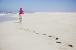 Rear view of a man walking on sand