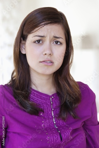 Photo: Portrait of a young woman looking sad Portrait of a young woman looking sad
