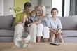 Couple watching television with their sons