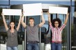 Three friends protesting with blank placards