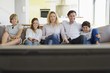 Family watching TV together at home
