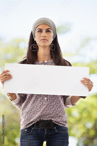 Photo: Woman holding a blank placard Woman holding a blank placard