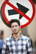 Handsome man smiling with no entry sign in the background