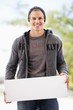 Portrait of a man holding a blank placard