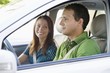 Happy couple driving a car
