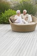 Senior couple sitting in a wicker couch