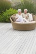 Senior couple sitting in a wicker couch