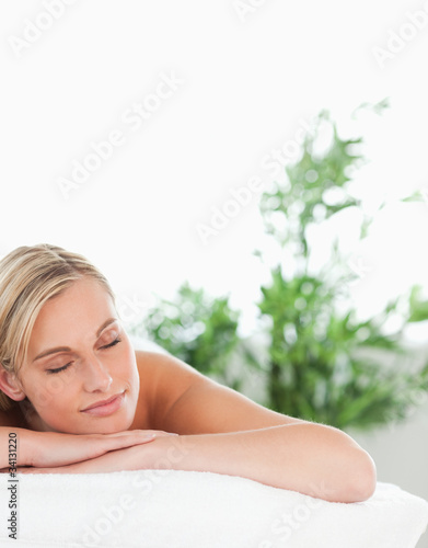 Photo: Close up of a cheerful blonde woman lying on a lounger Close up of a cheerful blonde woman lying on a lounger