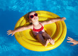 little girl swims in a pool