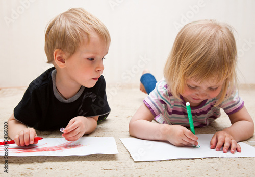 Photo: Boy and girl are painting Boy and girl are painting