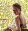 Photo: Young woman in the French balcony enjoying spring Young woman in the French balcony enjoying spring